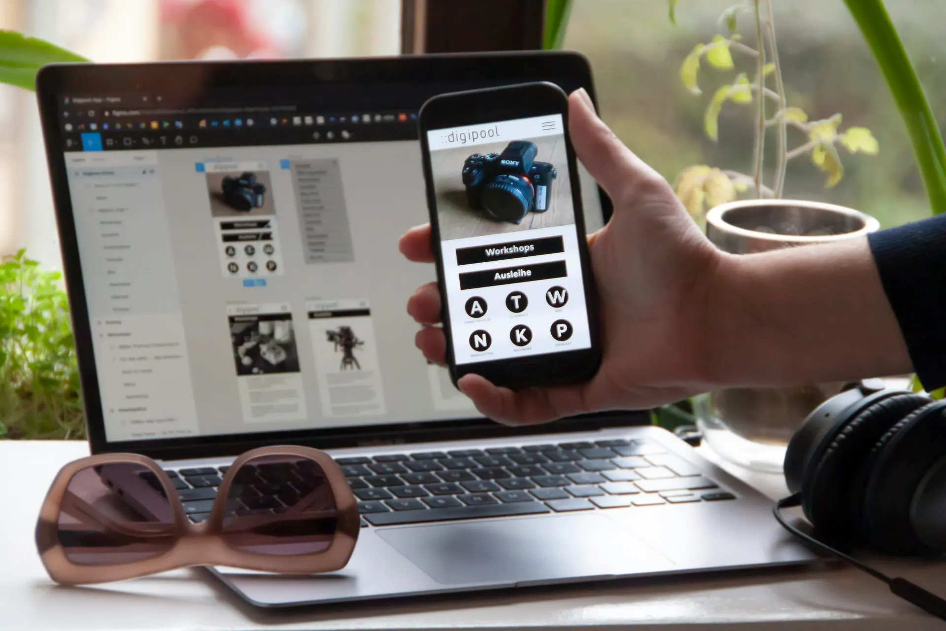 Mobile app interface shown in front of a laptop